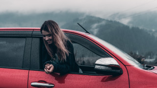 Woman red car window smiling - her phone free wallpaper