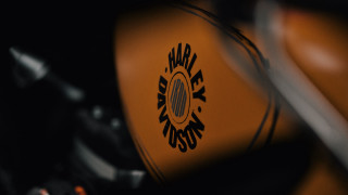 Motorcycle logo closeup black background - a yellow motorcycle free wallpaper