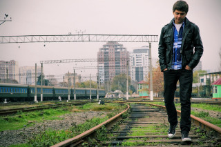 Man standing train track city - daryush shokof free wallpaper
