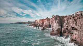 Rocky cliff water mountain sky - a cliff face free wallpaper