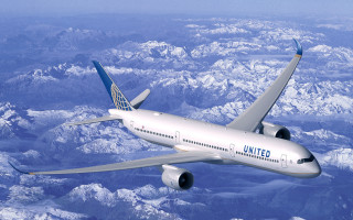 Jetliner flying over mountains blue - a large jetliner free wallpaper