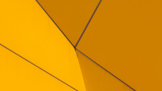 Yellow wall metal wire clock - a yellow wall free wallpaper