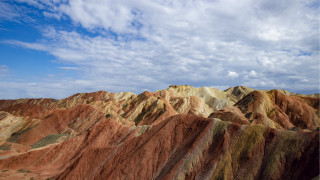 Mountain range cloudy sky castle 2 - a view of a mountain range free wallpaper