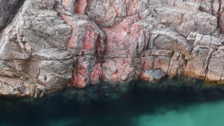 Large rock formation water cliff 2 - a body of water below free wallpaper