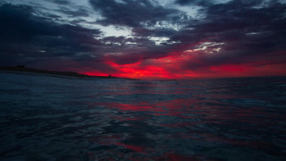Red blue sky ocean island - a small island in the distance free wallpaper