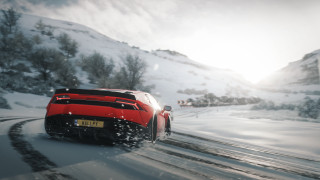 Red sports car snowy mountains 2 - cinematic focus free wallpaper