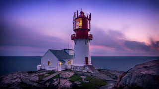 Lighthouse rocky shore purple sky - a lighthouse free wallpaper