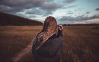 Woman field sky clouds shallow - her back free wallpaper