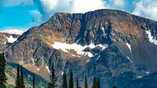 Snowy mountain forest blue sky - a mountain free wallpaper