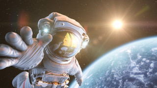 Space suit man waving planet - a planet in the background free wallpaper for desktop