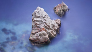 Rock formation water blue sky - a rock formation free wallpaper