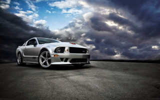 Silver mustang parking lot cloudy - a parking lot under a cloudy sky free wallpaper