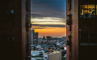 Cityscape sunset dawn skyscrapers ocean - a view of a city free wallpaper
