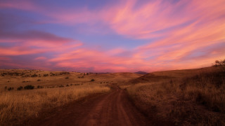 Dirt road sunset clouds hill - a hill in the distance free wallpaper for desktop