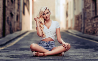 Woman sitting beach blonde denim - her hand behind her head free wallpaper for desktop