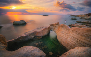 Ocean sunset rock formation mountain - a rock formation in the ocean free wallpaper