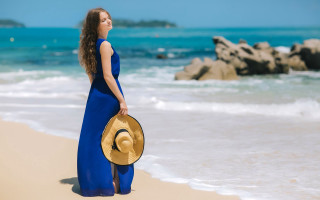 Woman blue dress straw hat - a rock formation in the background free wallpaper