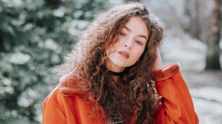 Woman curlyhair orangejacket woods portrait - brigette barrager free wallpaper