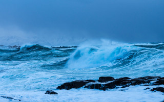 Stormy ocean wave lighthouse rocks - a lighthouse in the distance free wallpaper