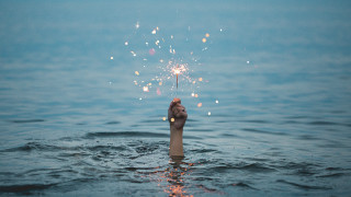 Hand sparkler water sky beach - a sparkler free wallpaper