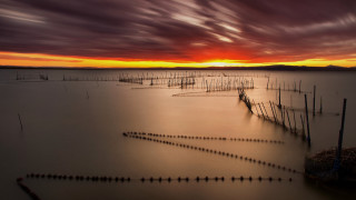 Poles sunset ocean clouds hourglass - a sunset in the background free wallpaper for desktop