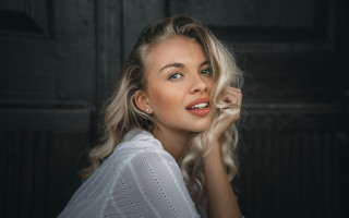 Blonde woman white shirt hand 4 - her cheek free wallpaper