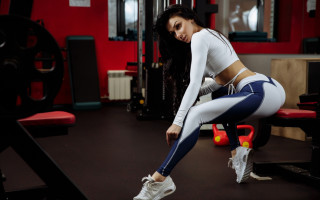 Woman squatting gym bench ball - full body pose free wallpaper