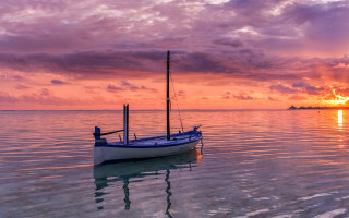 Small boat water reflection sunset - rich moody colours free wallpaper