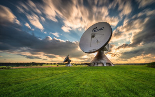 Satellite dish green field cloudy - a sun setting free wallpaper