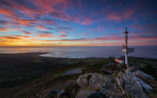 Lighthouse hill sunset water city - a sunset in the background and a body of water free wallpaper