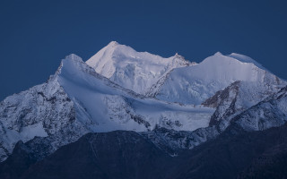 Snowy mountain dark sky clouds - a dark sky in the background free wallpaper