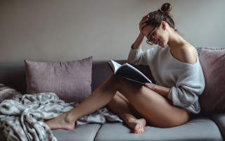 Woman reading couch glasses barefoot - glass free wallpaper
