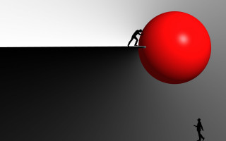 Man pushing red ball up - extreme free wallpaper