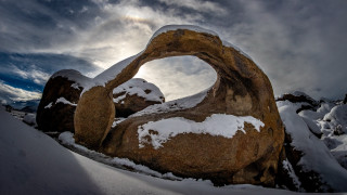 Rock formation sun peeking snowy - wide angle len free wallpaper