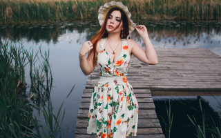 Woman dress hat dock water - a boat in the background free wallpaper