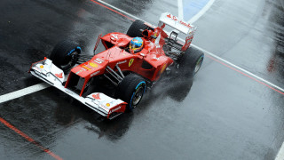 Red racecar wet track rain - a red race car free wallpaper