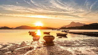 Sunset boats water beach lighthouse - a couple of boats free wallpaper