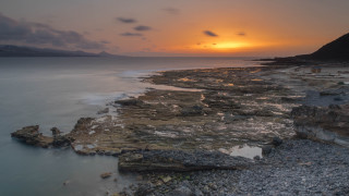 Sunset rocky beach mountains city - sunrise free wallpaper for desktop