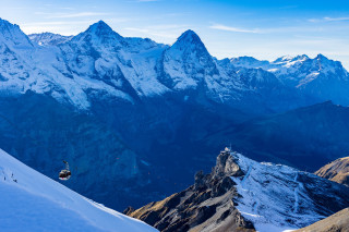 Snowboarder snowy mountain top background - a snowboard free wallpaper