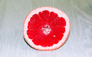 Grapefruit half tabletop white background - half free wallpaper