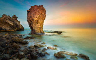 Beach sunset rock formation cloudy - a rock formation free wallpaper