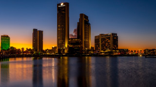 City skyline night water orange - orange glow free wallpaper