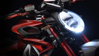 Motorcycle closeup headlight black background - a close up of a motorcycle free wallpaper
