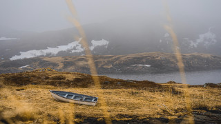 Boat grassy mountains snowy water - free winter wallpaper