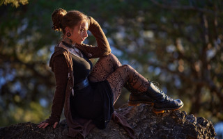 Woman sitting rock brown sweater - a rock free wallpaper