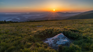 Sunset mountain range rock valley - a sunset over a mountain range free wallpaper