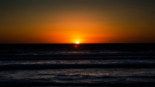 Sunset ocean bird boat mountain - a sunset over the ocean free wallpaper