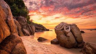 Rock formation beach sunset sky - a rock formation free wallpaper