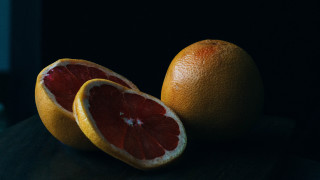 Grapefruits halved stilllife darkbackground neo - neofauvism free wallpaper