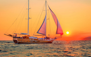 Sailboat sunset ocean sky sails - the sun setting behind free wallpaper